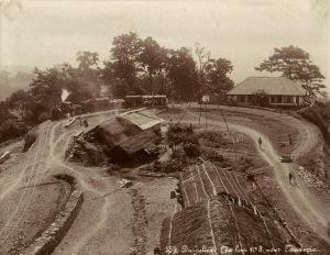 The track loop: trains climbed up to Darjeeling, then turned around and headed back down; an albumen print, c.1870; *another view of the Darjeeling track loop, c.1880's*; *another Darjeeling railway scene, c.1890's